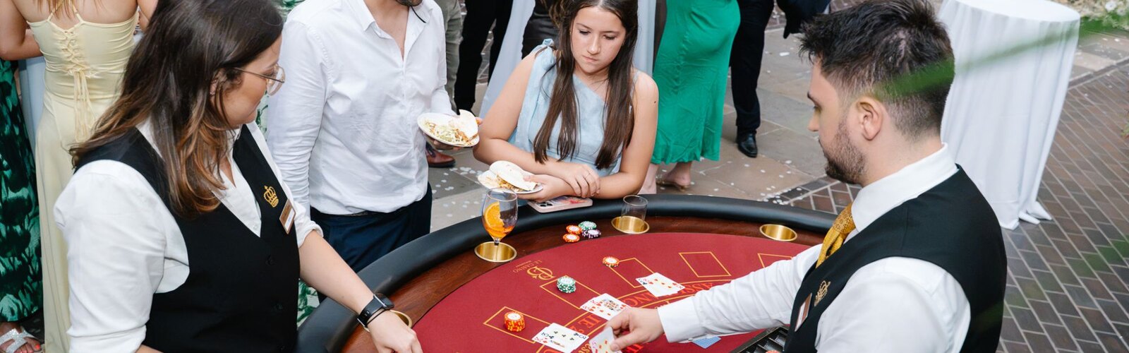 Royale croupiers hosting a blackjack table for guests at a Barbican Conservatory wedding
