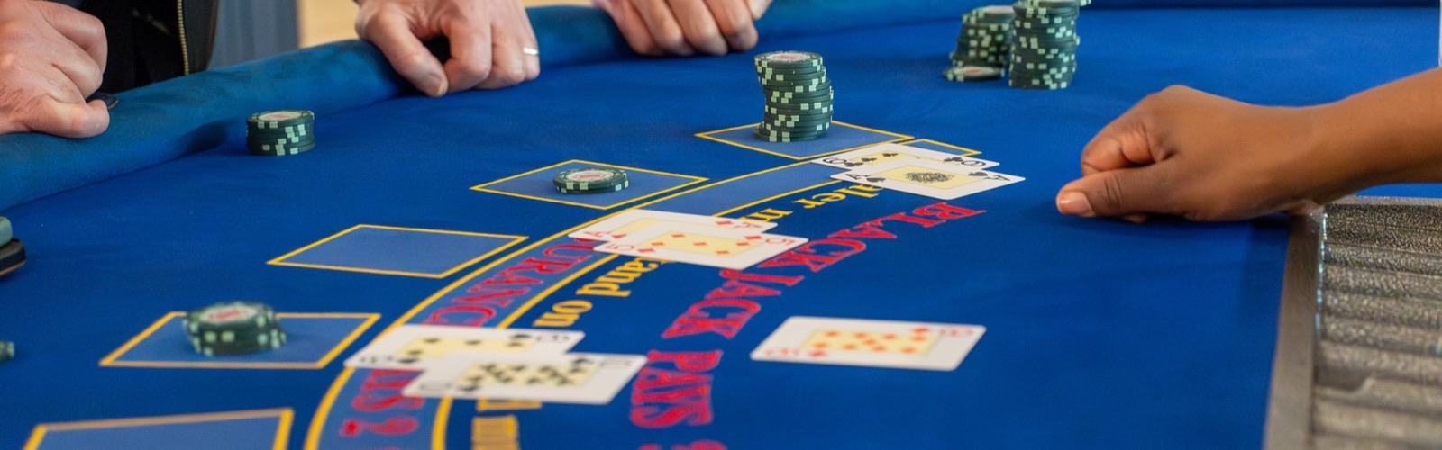 Black-tie guests playing blackjack at a Royale Casino Hire wedding event
