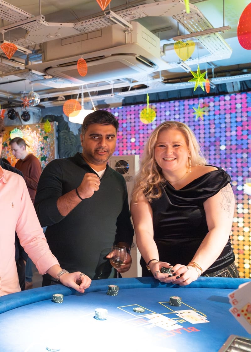 Birthday party casino hire: guests at a blackjack table at a milestone celebration