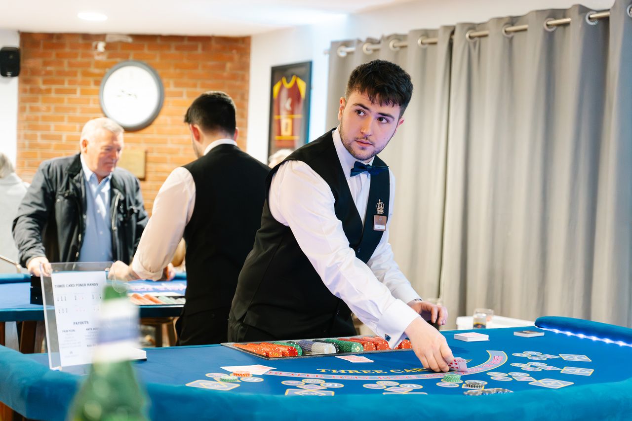 A uniformed Royale croupier at the roulette table before guests arrive