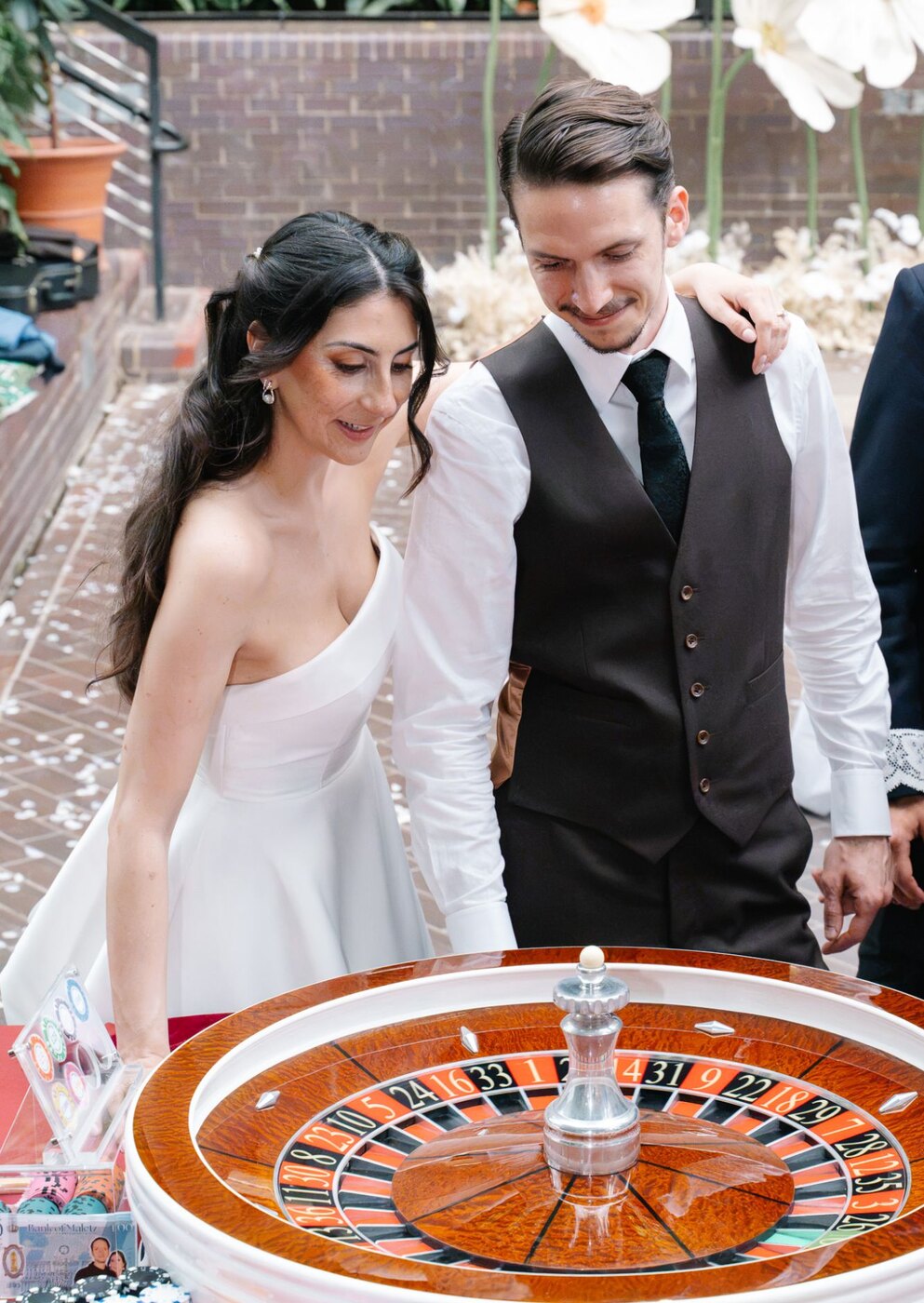 A newly married couple at the roulette wheel during their Barbican Conservatory wedding
