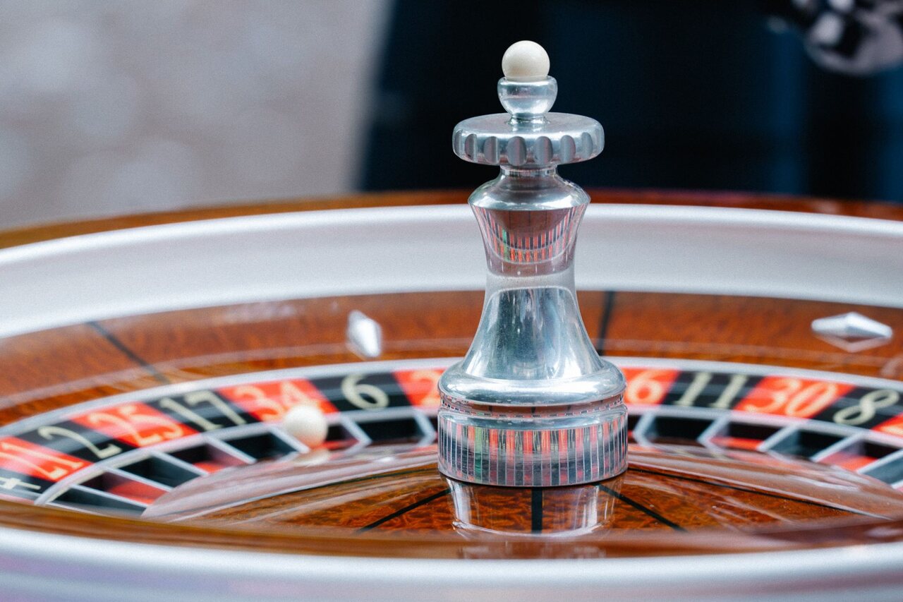 A polished mahogany roulette wheel in play at a Royale wedding casino