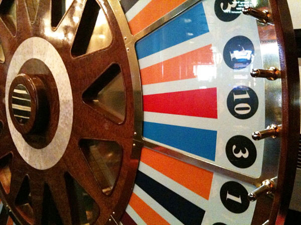 Close-up of a Royale wheel of fortune showing the painted segments and gold pegs
